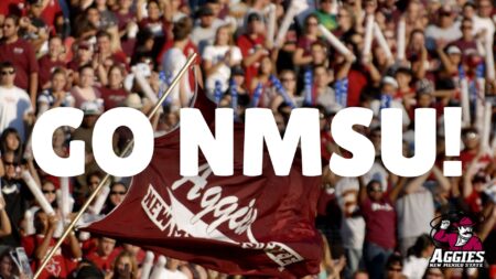 A banner captioned "GO NMSU!". The background of the banner is a blurred photo of a sports crowd.